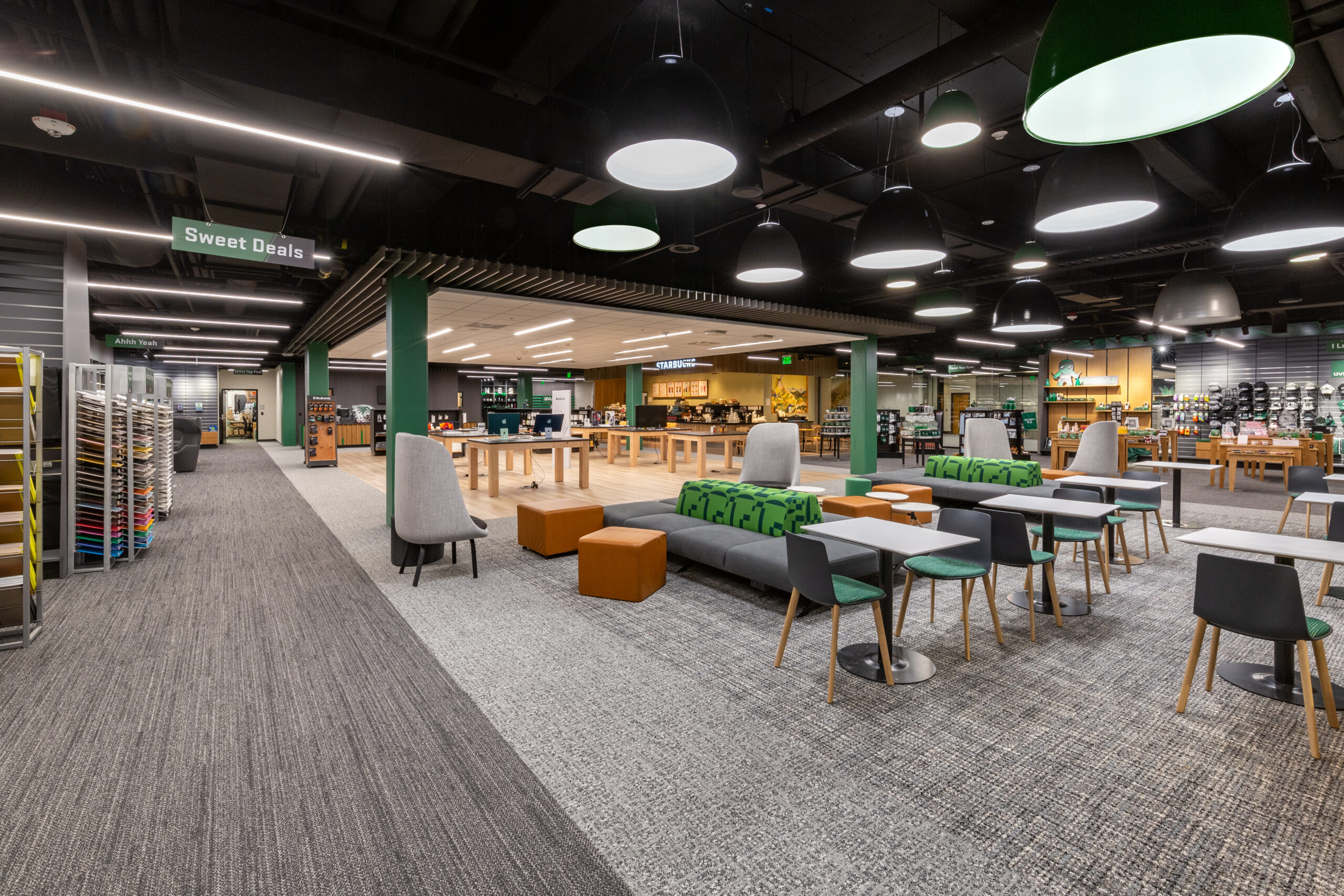 Campus gathering space illuminated by pendant lights